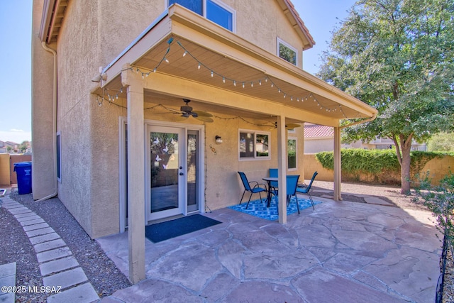 view of patio featuring fence and a ceiling fan