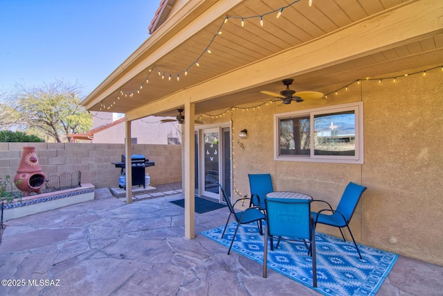 view of patio / terrace featuring ceiling fan, a grill, fence, and outdoor dining area