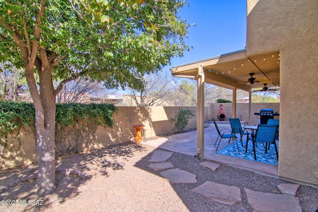 view of patio / terrace with a fenced backyard, a ceiling fan, and area for grilling