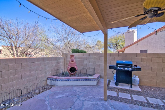 view of patio with a fenced backyard, a grill, and a ceiling fan