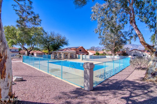 community pool featuring fence and a patio