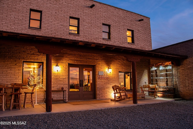 back house at dusk with a patio