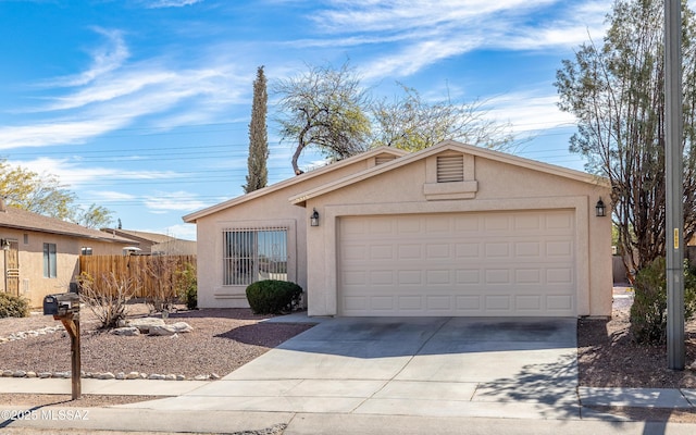 view of front of property featuring an attached garage, fence, concrete driveway, and stucco siding