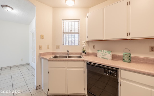 kitchen with dishwasher, light countertops, white cabinetry, a sink, and light tile patterned flooring