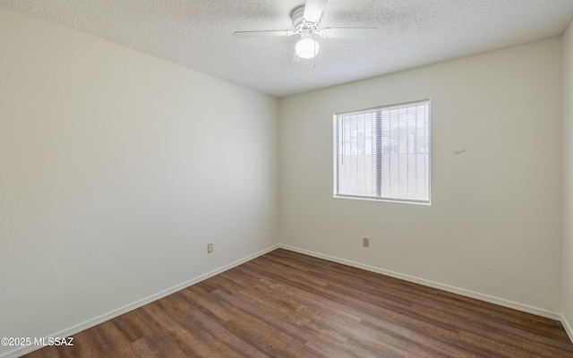 empty room with a textured ceiling, ceiling fan, wood finished floors, and baseboards