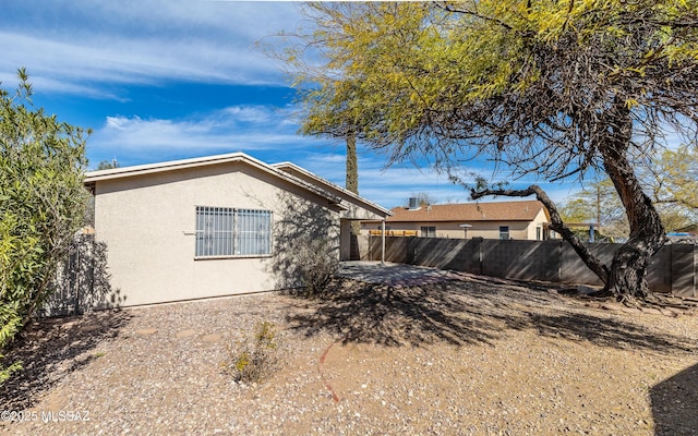 view of home's exterior featuring a fenced backyard, a patio, and stucco siding