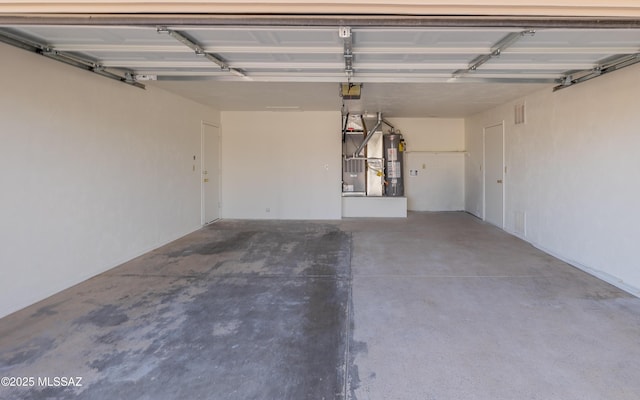 garage with a garage door opener and gas water heater