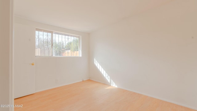 spare room with light hardwood / wood-style floors