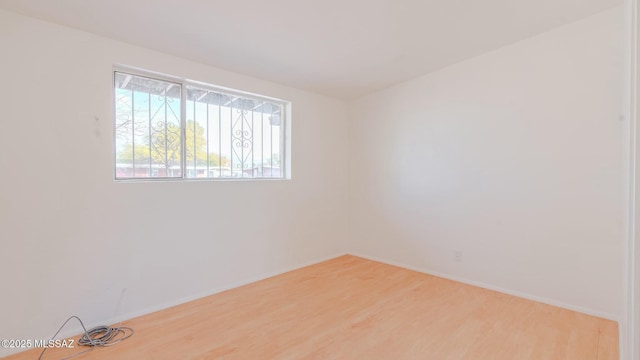 empty room featuring hardwood / wood-style flooring