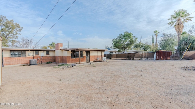 rear view of property featuring central AC unit