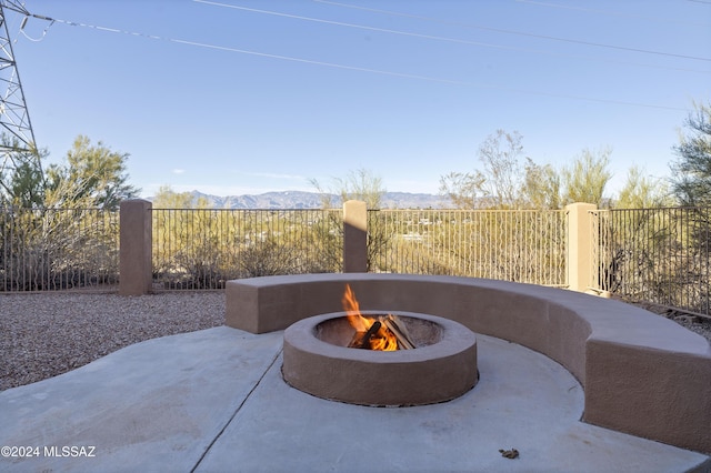 view of patio featuring a mountain view and a fire pit