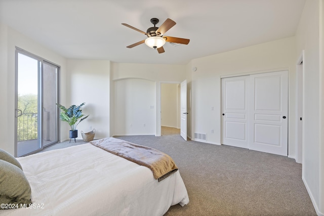 bedroom with a closet, ceiling fan, and carpet flooring