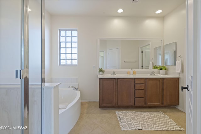 bathroom featuring vanity, tile patterned flooring, and separate shower and tub