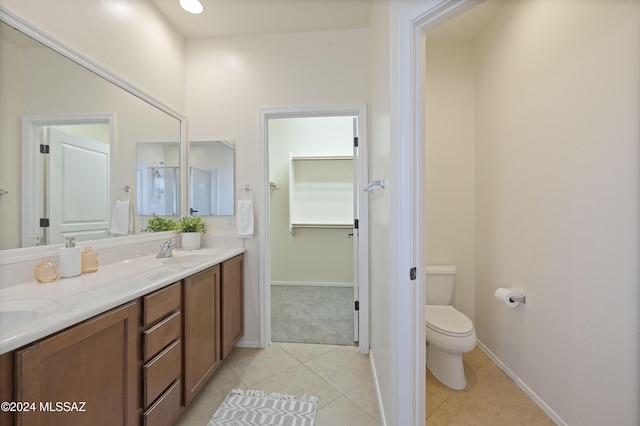 bathroom featuring tile patterned flooring, vanity, and toilet