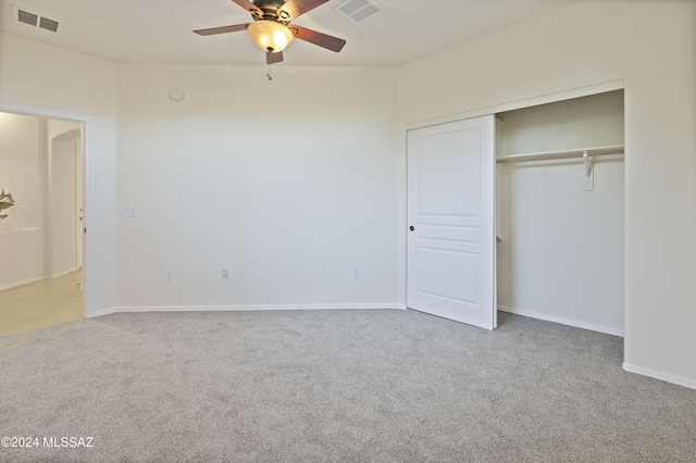 unfurnished bedroom with carpet flooring, ceiling fan, and a closet