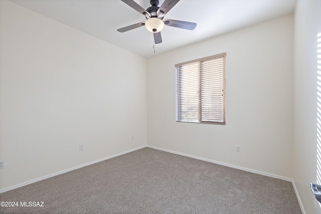 spare room featuring ceiling fan and carpet floors