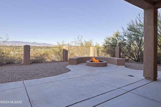 view of patio featuring a mountain view and an outdoor fire pit