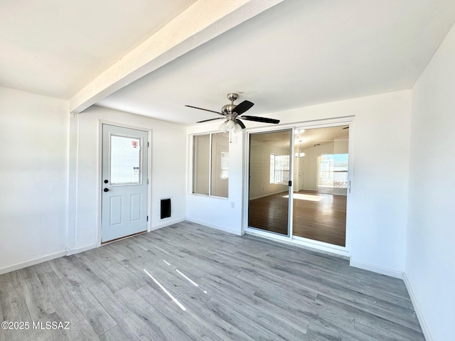 interior space featuring wood finished floors, baseboards, and ceiling fan