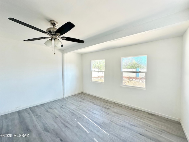 unfurnished room featuring baseboards, wood finished floors, and a ceiling fan