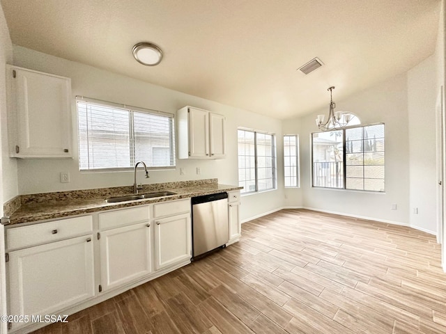 kitchen with pendant lighting, sink, dishwasher, white cabinetry, and light hardwood / wood-style floors