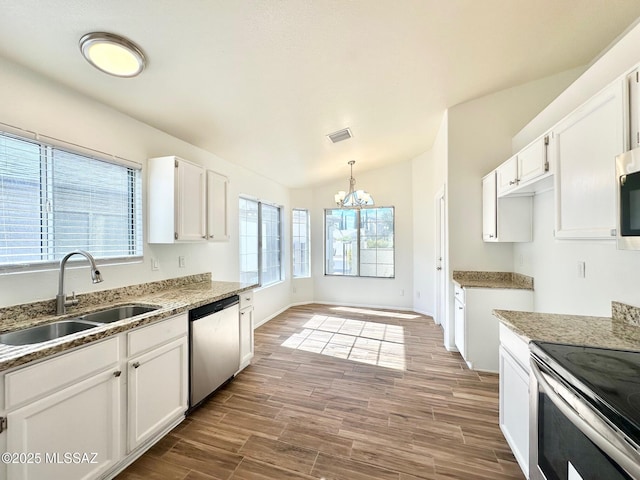 kitchen with a sink, wood finish floors, visible vents, and stainless steel appliances