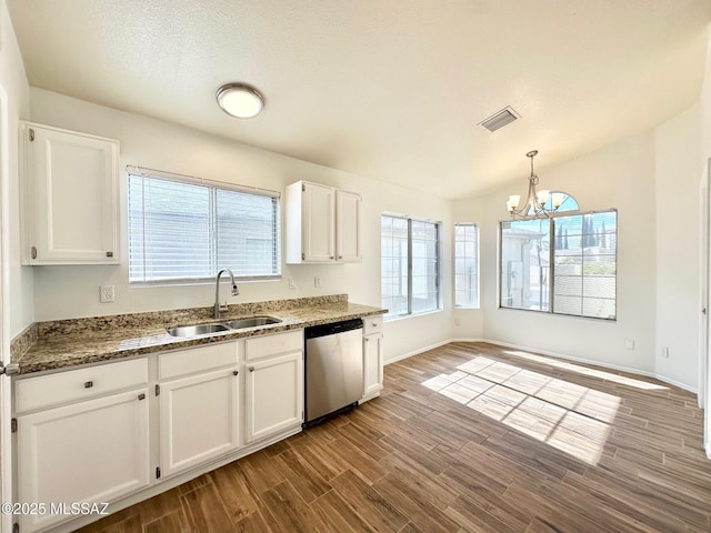 kitchen with visible vents, a sink, stainless steel dishwasher, wood finished floors, and white cabinets