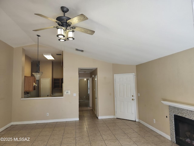 unfurnished living room featuring light tile patterned flooring, ceiling fan, a fireplace, and vaulted ceiling