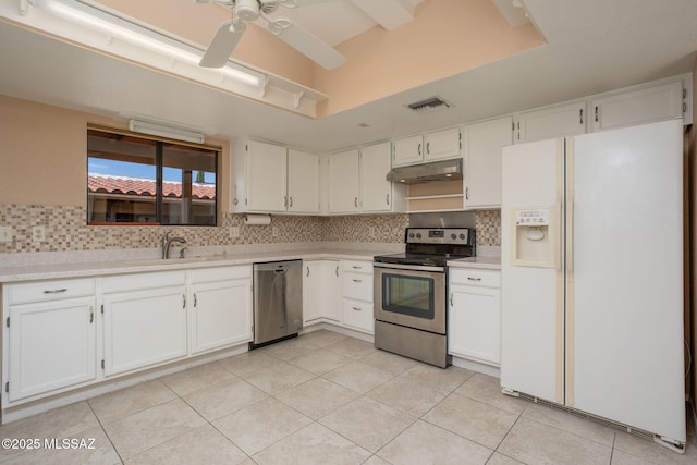 kitchen with under cabinet range hood, white cabinetry, visible vents, light countertops, and appliances with stainless steel finishes