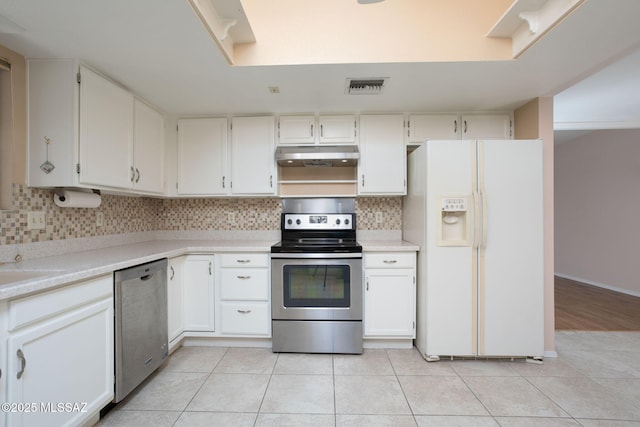 kitchen featuring visible vents, appliances with stainless steel finishes, under cabinet range hood, backsplash, and light tile patterned flooring