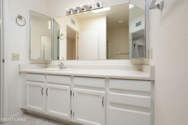 bathroom featuring visible vents and vanity