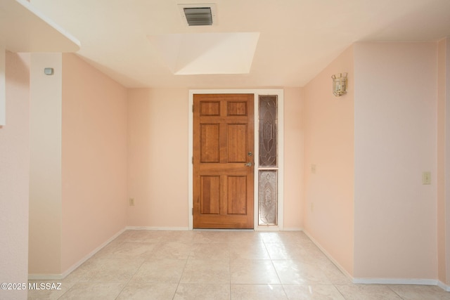 spare room with light tile patterned floors, baseboards, and visible vents