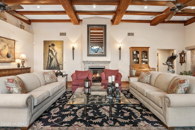 living room featuring beamed ceiling, ceiling fan, and coffered ceiling