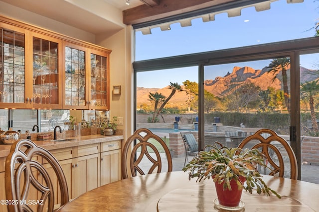 dining space featuring a mountain view and sink