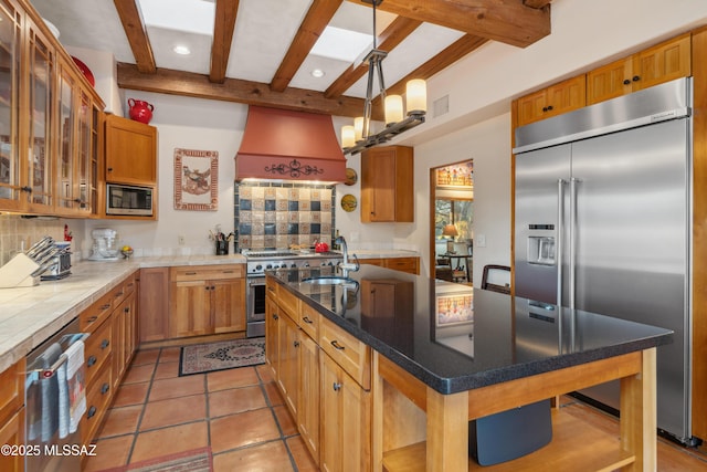 kitchen with built in appliances, sink, custom exhaust hood, and tasteful backsplash