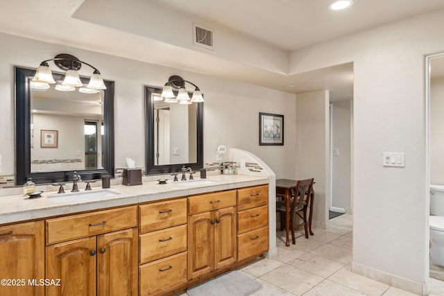 bathroom with tile patterned floors, vanity, and toilet