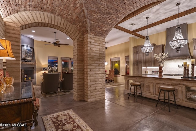 bar with brick ceiling, finished concrete floors, arched walkways, and decorative light fixtures