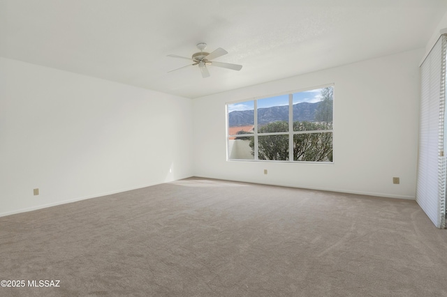 unfurnished room with ceiling fan and carpet floors