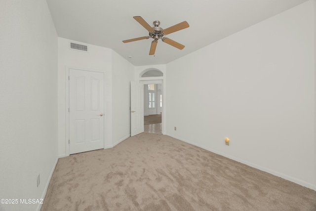 unfurnished bedroom featuring light carpet and ceiling fan