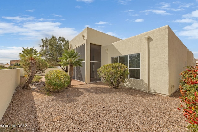 view of home's exterior with a sunroom