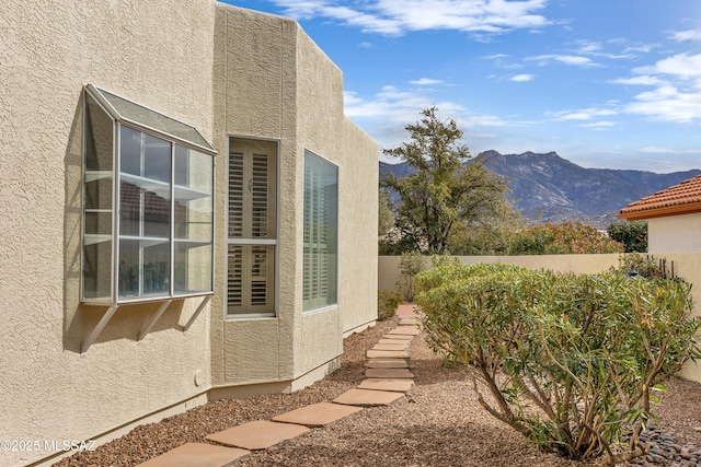 view of side of home featuring a mountain view