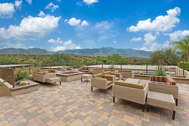 view of patio / terrace featuring a mountain view and an outdoor fire pit