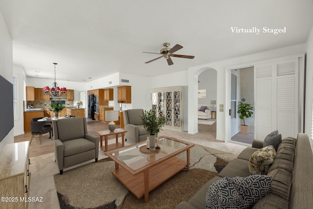 living room featuring ceiling fan and a healthy amount of sunlight