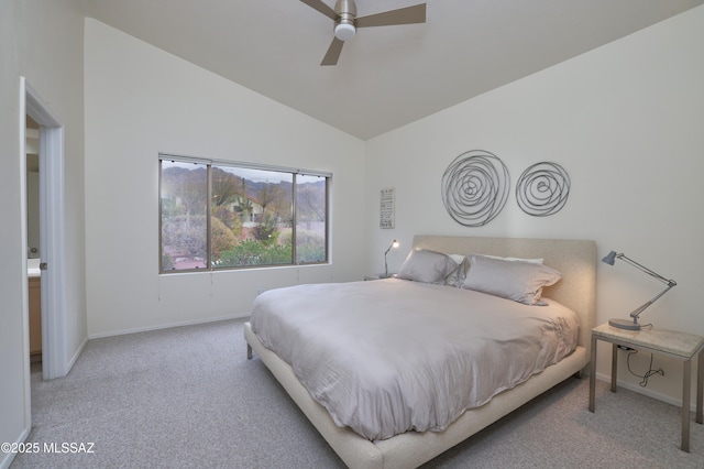 carpeted bedroom featuring baseboards, lofted ceiling, and a ceiling fan