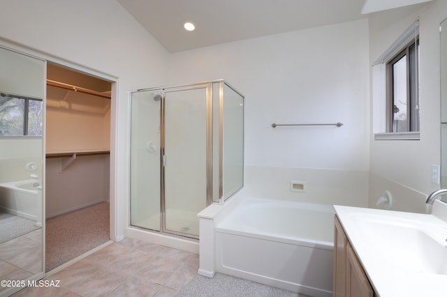 bathroom with a healthy amount of sunlight, a stall shower, and a garden tub