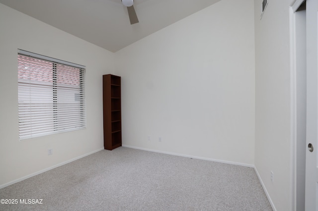 carpeted spare room featuring visible vents, baseboards, and ceiling fan