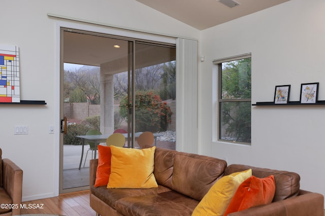 living room featuring lofted ceiling and wood finished floors