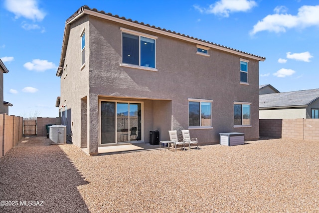 back of property featuring cooling unit, a patio area, a fenced backyard, and stucco siding