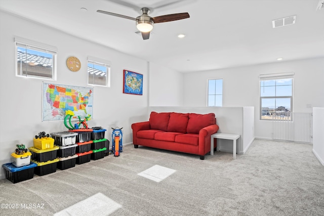 carpeted living room featuring plenty of natural light, visible vents, and recessed lighting