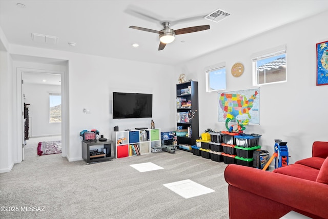 living room featuring carpet floors, visible vents, a ceiling fan, and recessed lighting