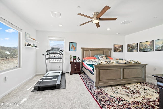 bedroom with baseboards, visible vents, ceiling fan, and light colored carpet